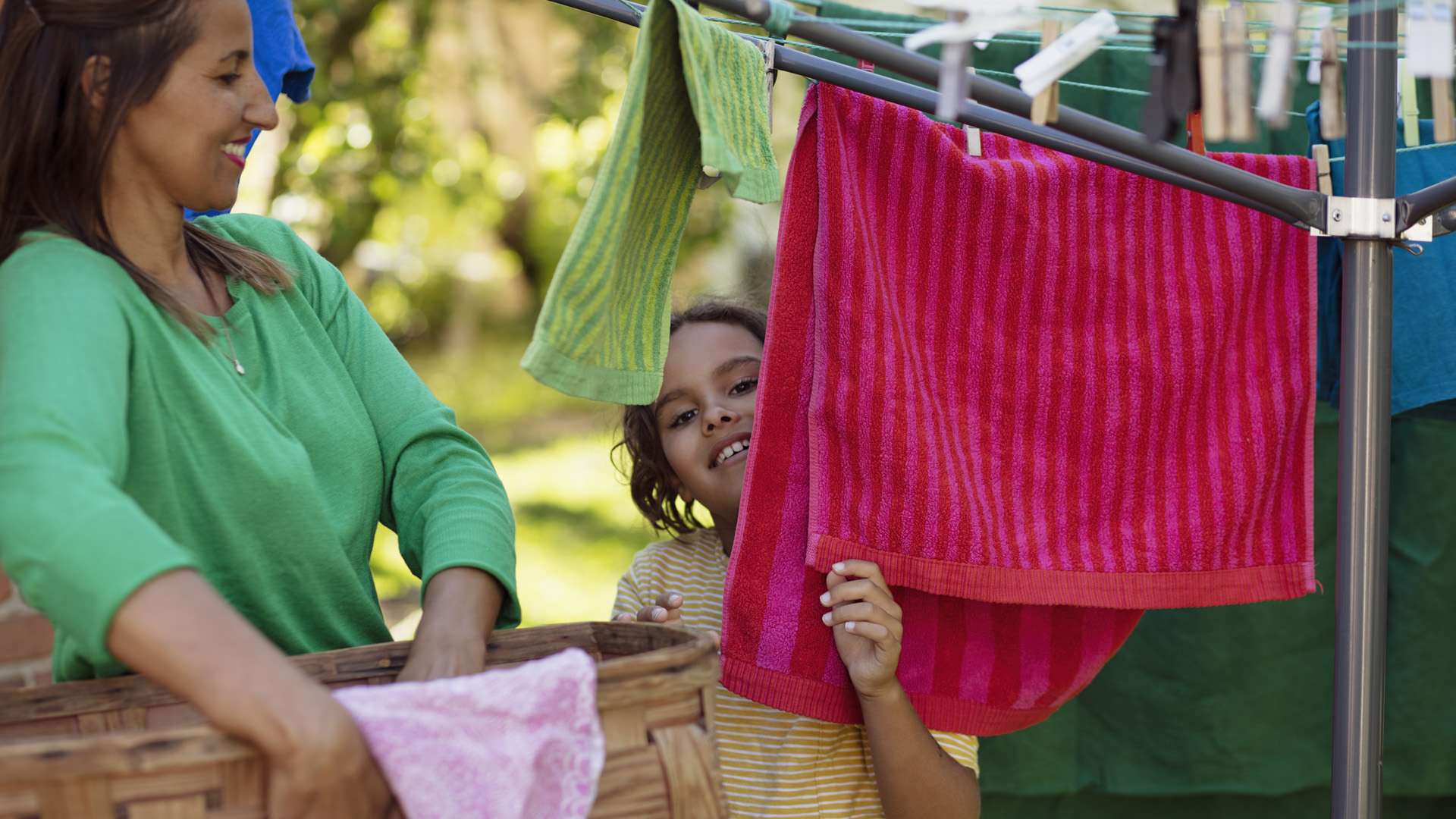 Kid and mother with laundry outside