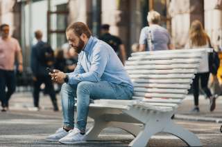 Man is sitting on a bench