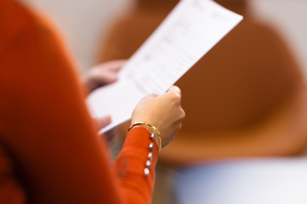 A woman's hands holding a paper application